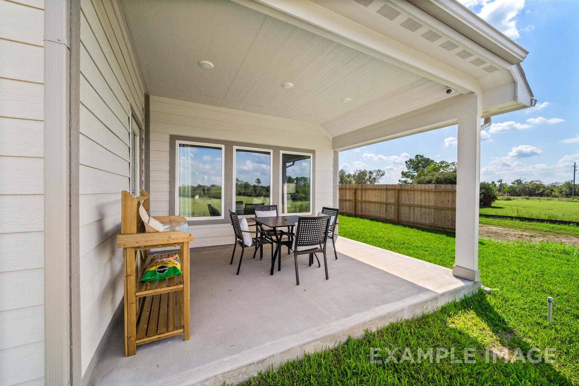 3311 Hidden Mist Drive Texas City, TX 77510 - Photo 34 of 37 a view of a patio with table and chairs potted plants with wooden floor
