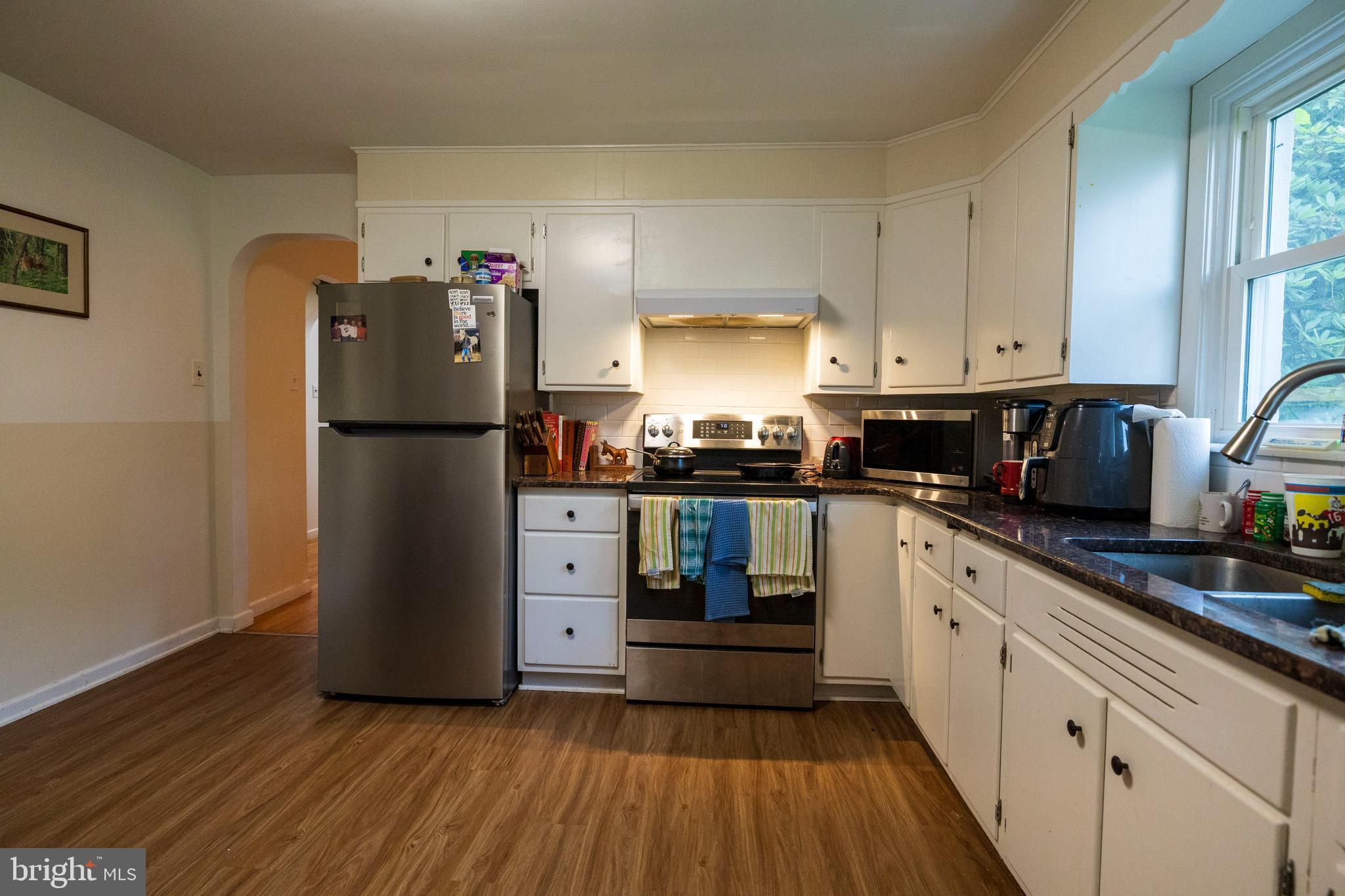 540 Doe Run Road Coatesville, PA 19320 - Photo 2 of 35 a kitchen with cabinets a refrigerator and a stove top oven