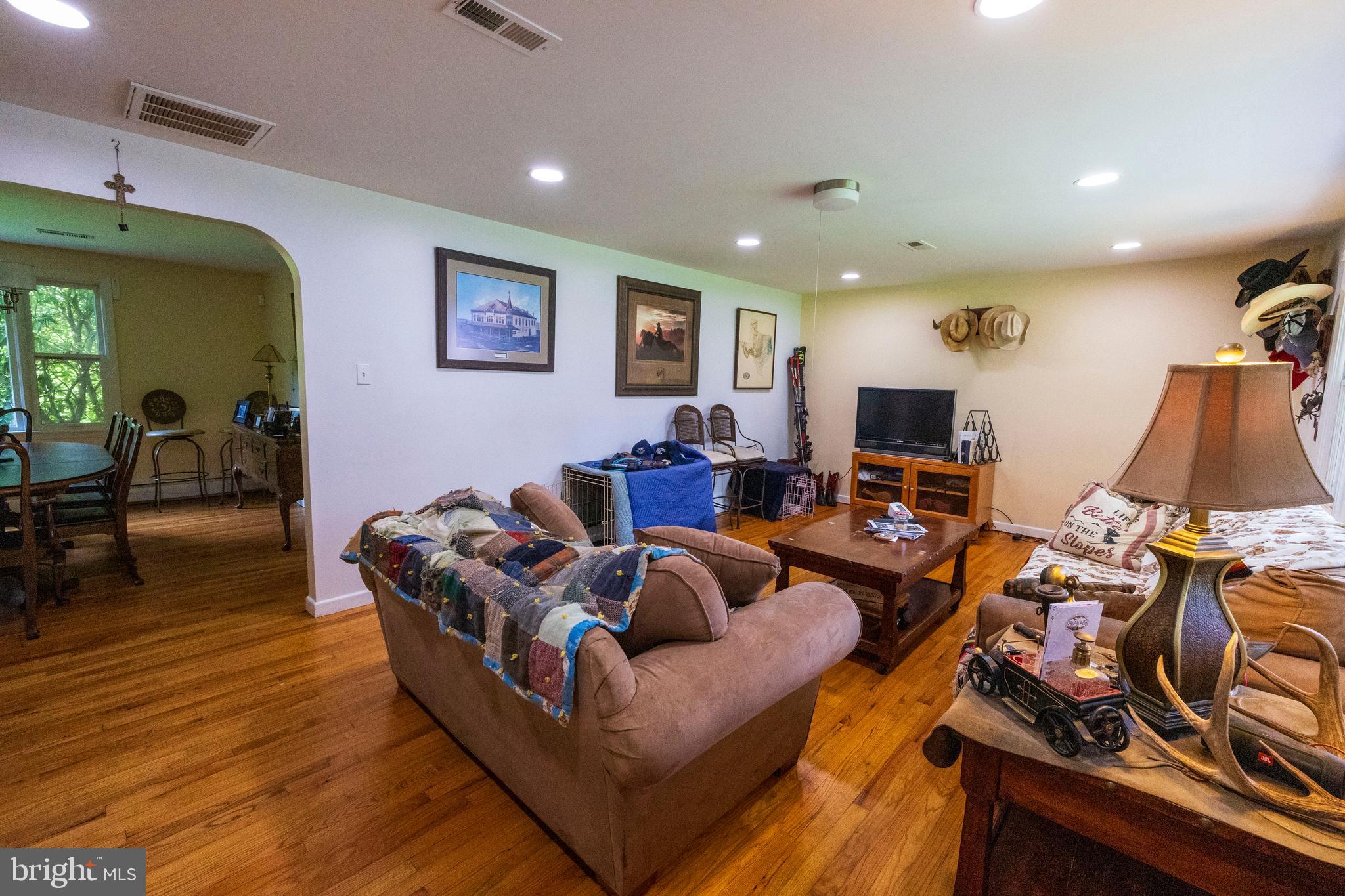 540 Doe Run Road Coatesville, PA 19320 - Photo 6 of 35 a living room with furniture a flat screen tv and a wooden floor