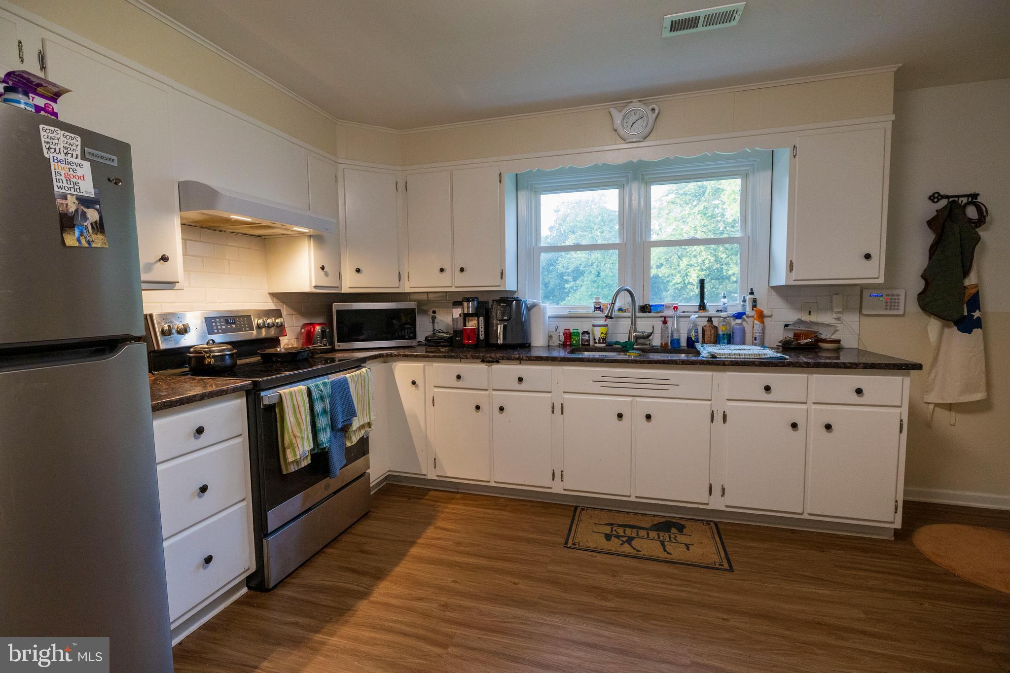 540 Doe Run Road Coatesville, PA 19320 - Photo 8 of 35 a kitchen with granite countertop white cabinets and white appliances