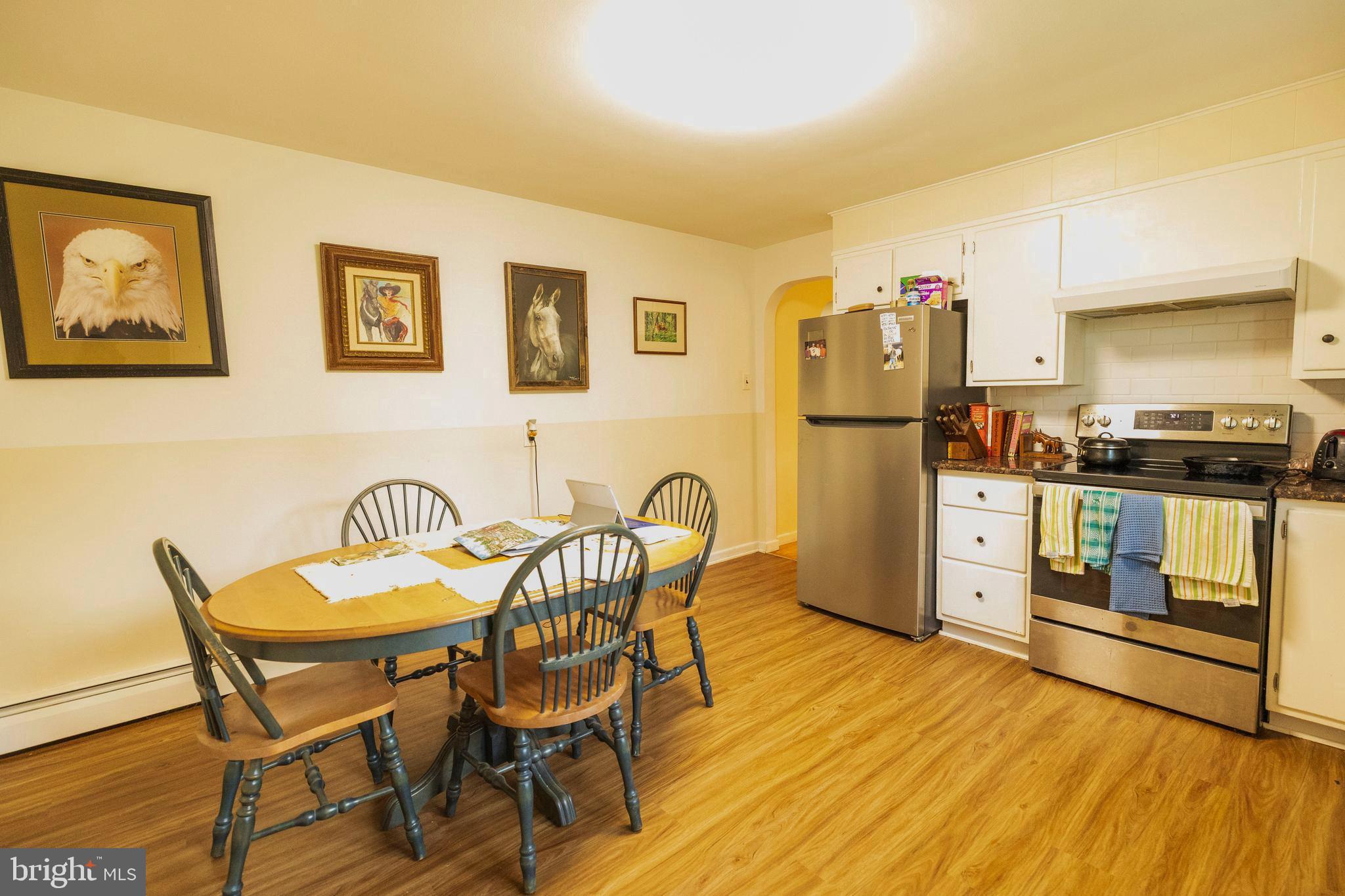 540 Doe Run Road Coatesville, PA 19320 - Photo 9 of 35 a kitchen with stainless steel appliances granite countertop a dining table and chairs