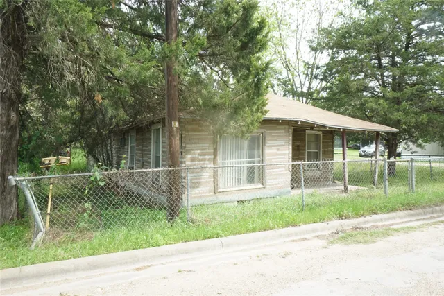 a front view of a house with a yard table and chairs