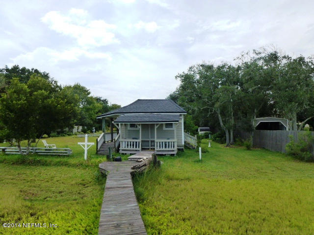 15775 Shellcracker Road Jacksonville, FL 32226 - Photo 2 of 25 a front view of a house with a yard and trees
