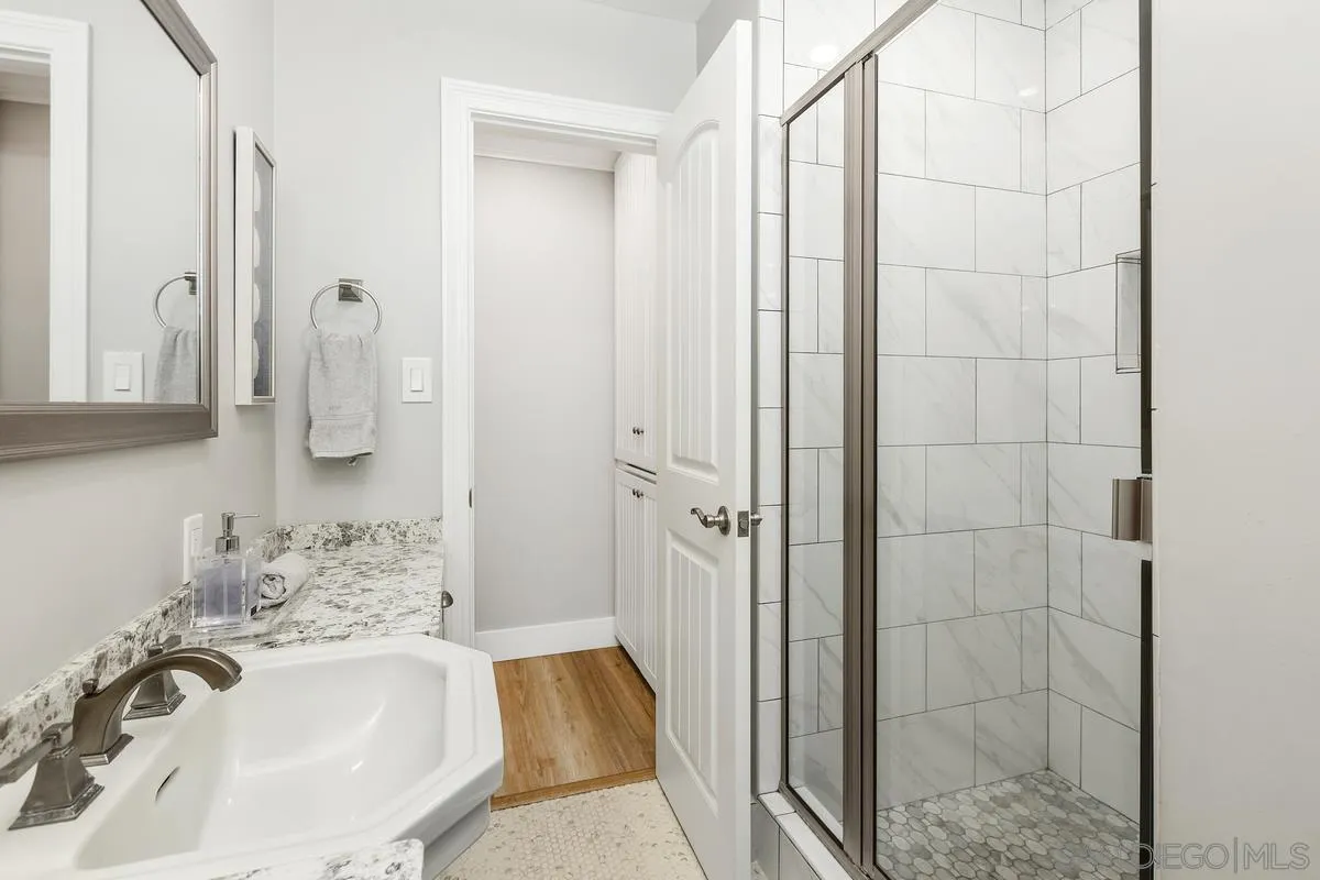 852 Olive Avenue Coronado, CA 92118 - Photo 12 of 12 a bathroom with a sink and mirror