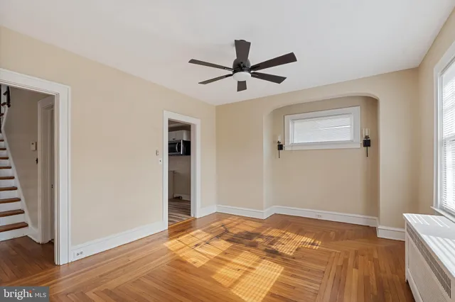 a view of a bedroom with wooden floor and closet