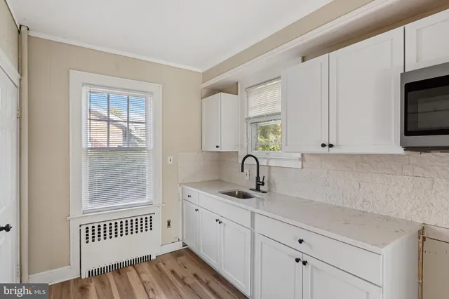 a kitchen with sink cabinets and window