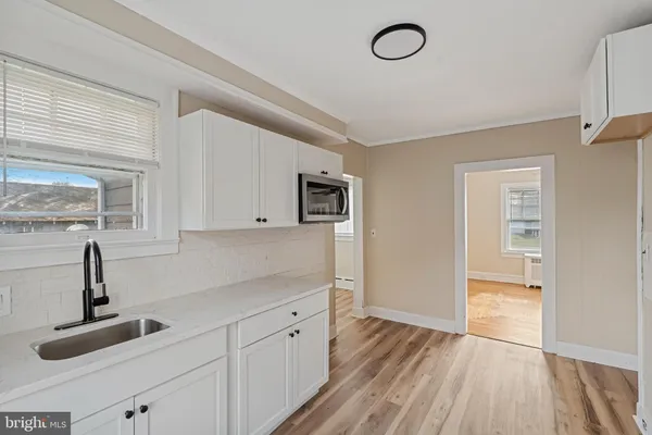 a kitchen with cabinets and window