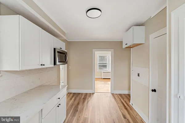 a view of empty room with wooden floor