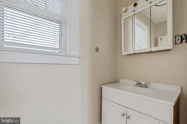 a bathroom with a sink and a window