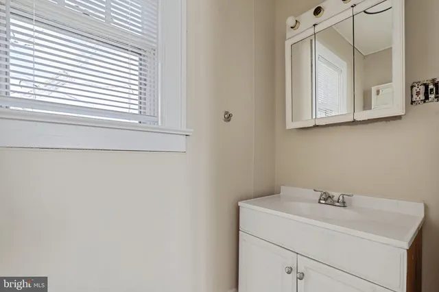 a bathroom with a sink and a window