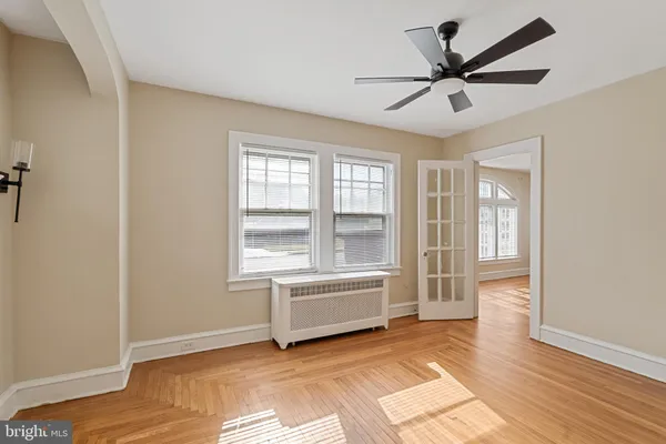 a view of a livingroom with a ceiling fan and window