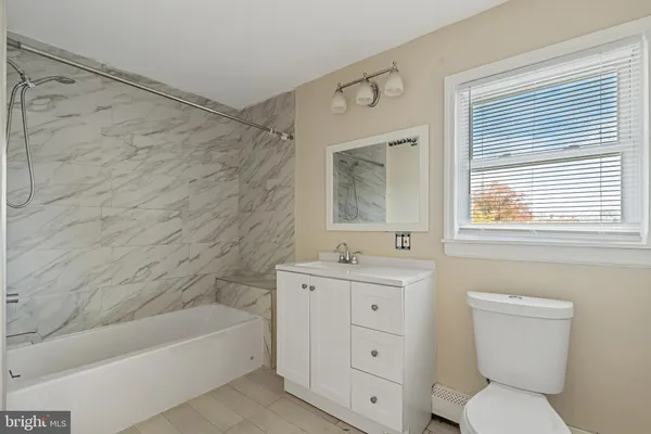 a bathroom with a toilet sink and bathtub