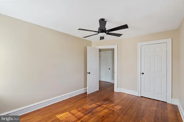 a view of an empty room and wooden floor