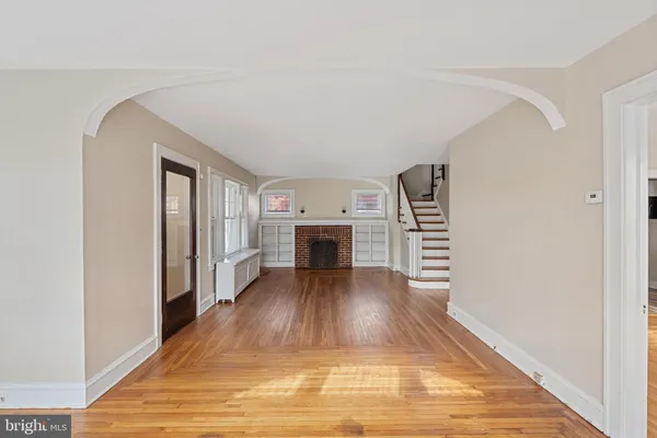 a view of a livingroom with wooden floor and fireplace