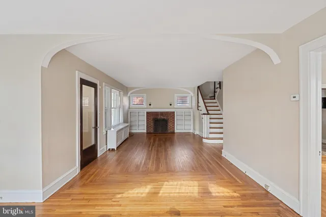 a view of a livingroom with wooden floor and fireplace