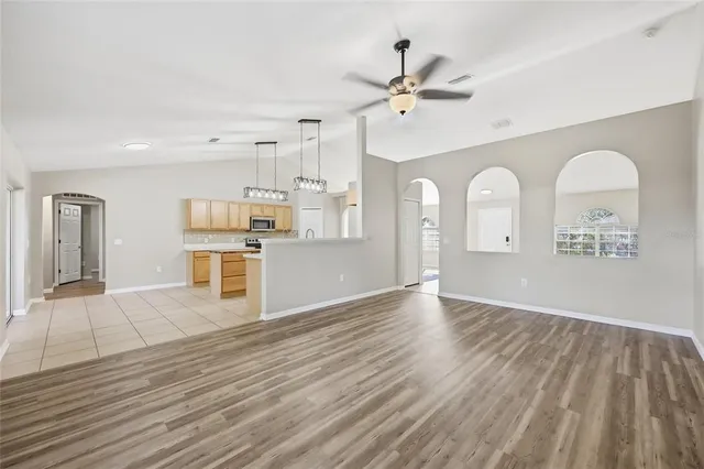 a view of a kitchen with wooden floor and a kitchen