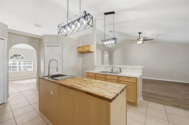 a kitchen with a sink a stove and cabinets