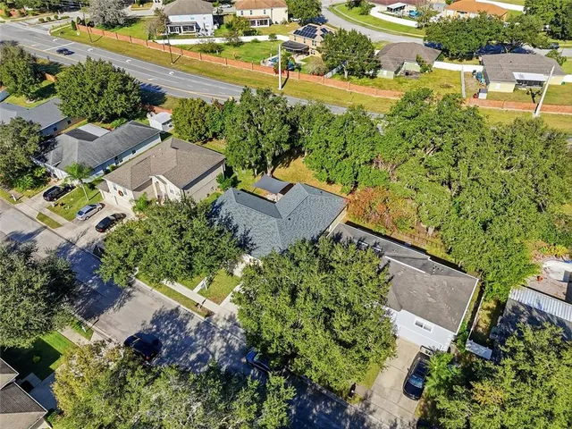 an aerial view of house with yard swimming pool and outdoor seating