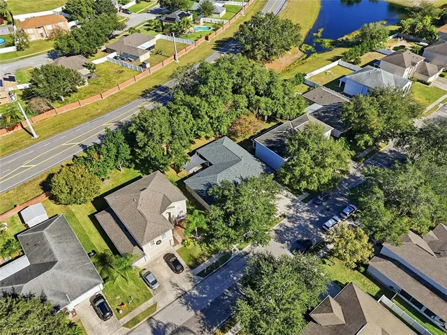 an aerial view of a house with a yard