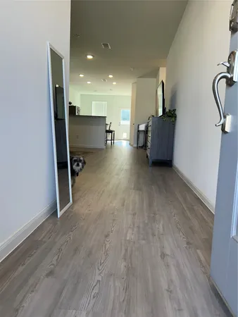 a view of a living room with furniture and wooden floor