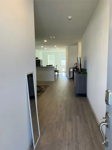 a view of a living room with furniture and wooden floor