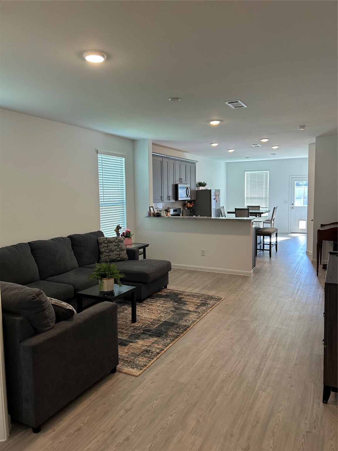 23415 Weir Box Road Hockley, TX 77447 - Photo 14 of 35 a living room with furniture and a dining table with kitchen view