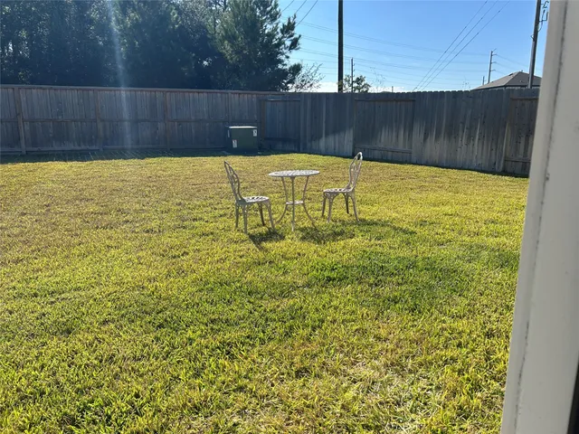a view of a swimming pool with wooden fence