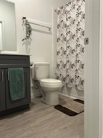 a bathroom with a toilet and a shower