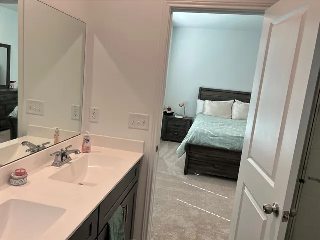 a en suite bathroom with a sink and a mirror