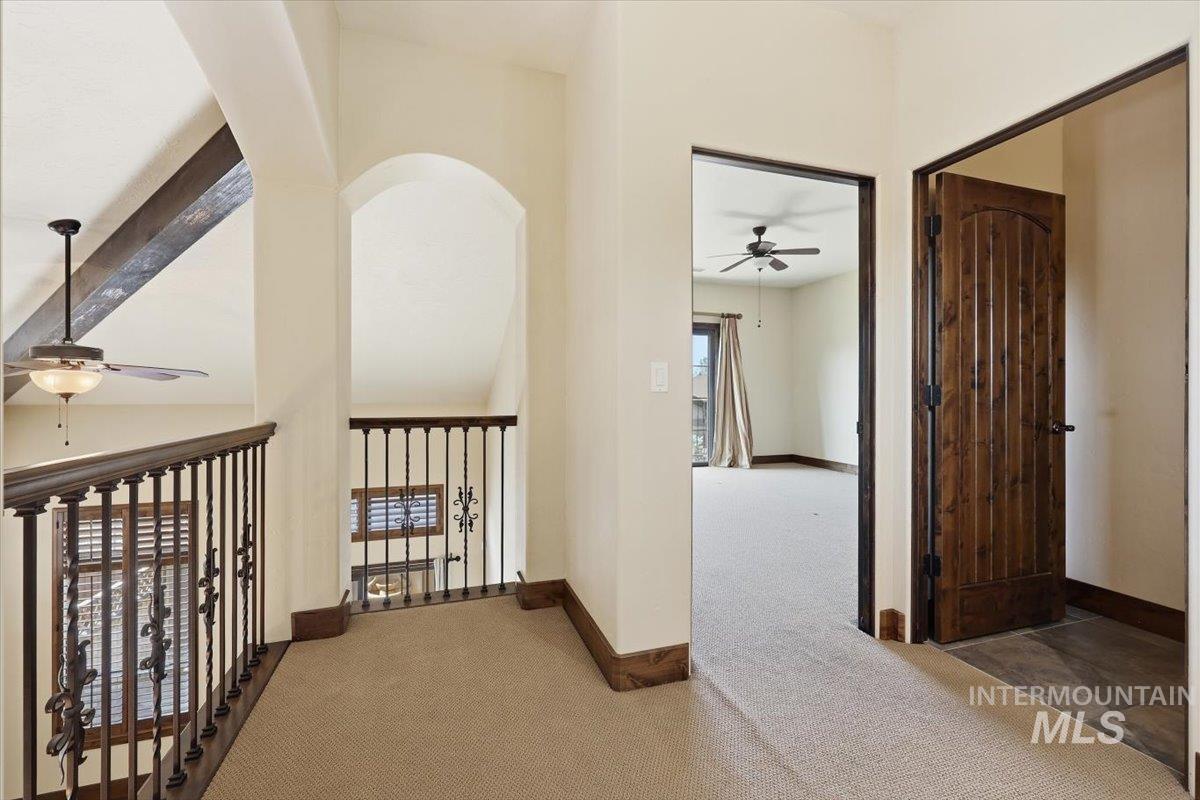 129 East Cholla Hills Street Meridian, ID 83646 - Photo 11 of 33 Spacious open-concept room featuring wood-finish flooring and a stone-clad fireplace with a wood mantel