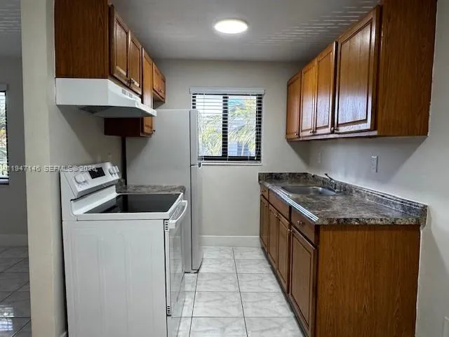 a kitchen with a stove and a sink