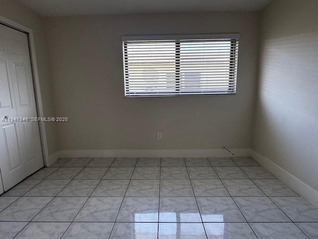 1310 West 29th Street, Unit 28 Hialeah, FL 33012 - Photo 5 of 12 an empty room with a window