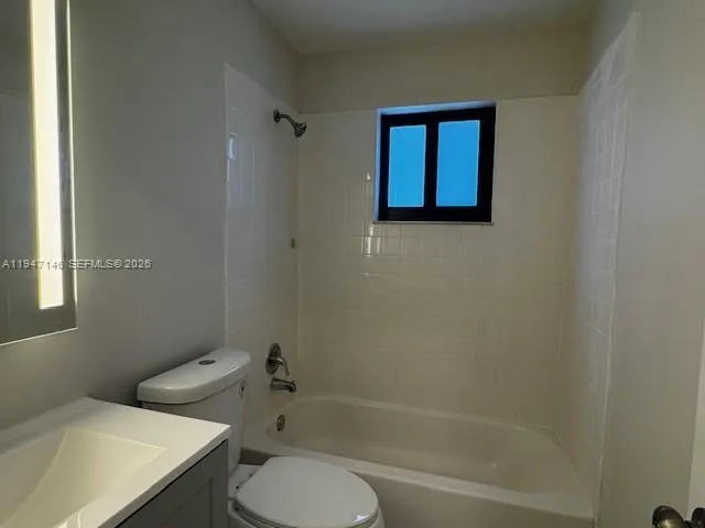 a bathroom with a toilet and a bathtub