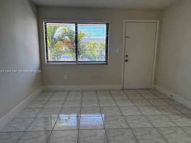1310 West 29th Street, Unit 28 Hialeah, FL 33012 - Photo 7 of 12 a view of a livingroom with an empty space and a window