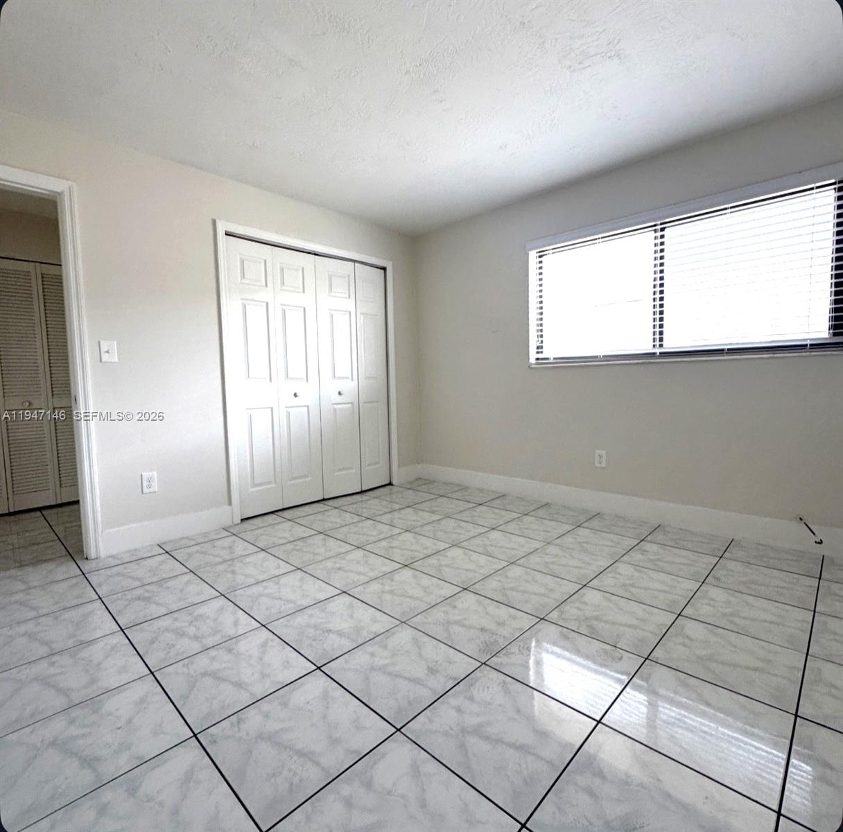 1310 West 29th Street, Unit 28 Hialeah, FL 33012 - Photo 7 of 10 a view of an empty room and window