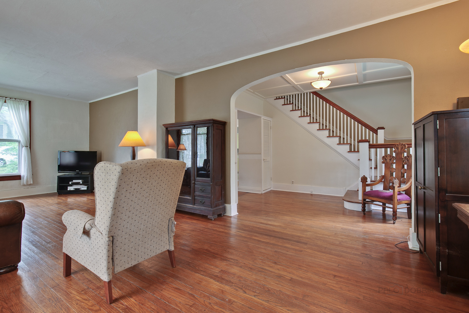 231 Spring Street Cary, IL 60013 - Photo 4 of 20 a living room with furniture and a dining room with wooden floor