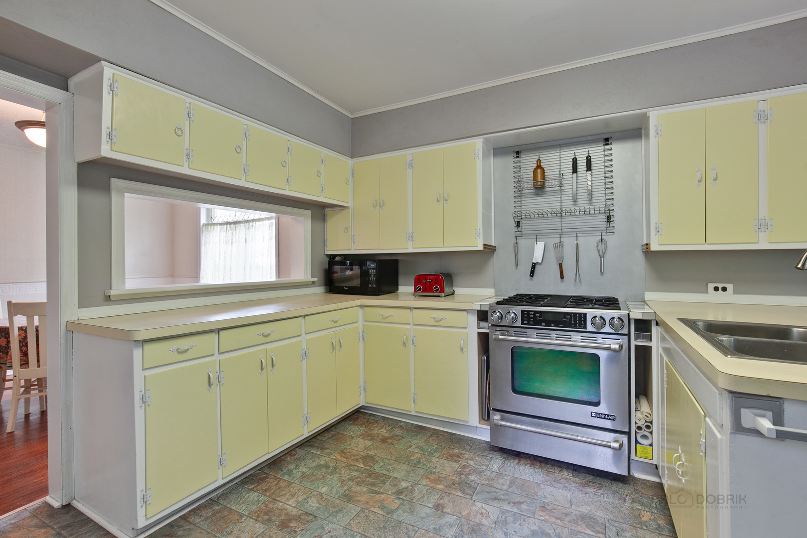 231 Spring Street Cary, IL 60013 - Photo 9 of 20 a kitchen with stainless steel appliances granite countertop a stove and a sink