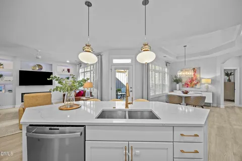 a kitchen with a sink and chandelier