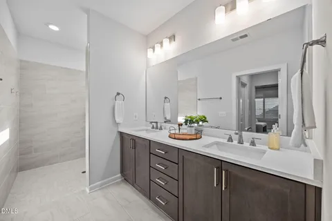 a bathroom with a sink double vanity and a mirror