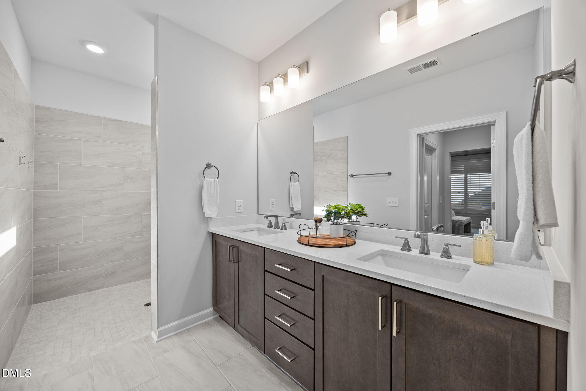 1405 Rich Inlet Cary, NC 27519 - Photo 16 of 44 a bathroom with a sink double vanity and a mirror