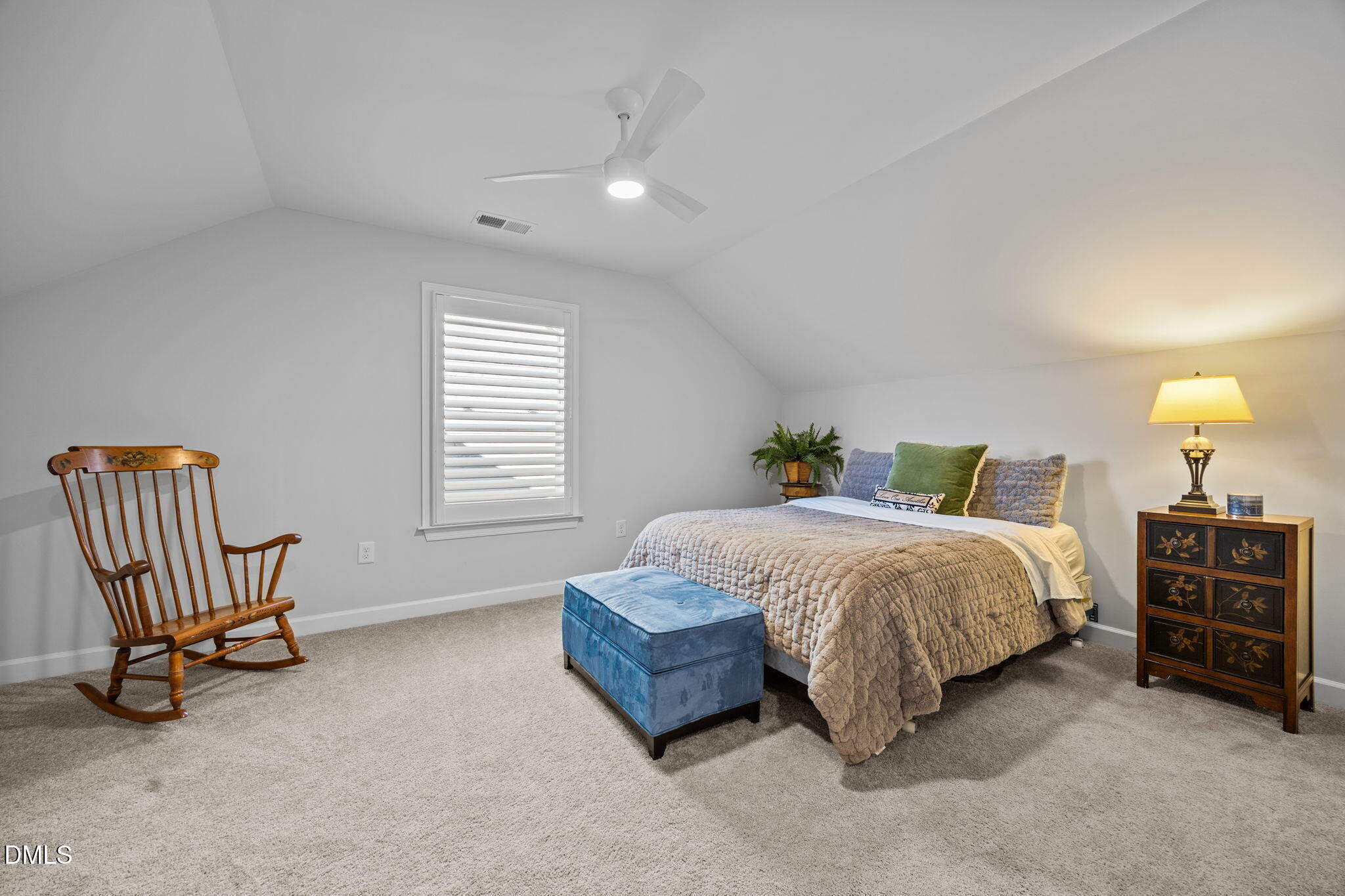1405 Rich Inlet Cary, NC 27519 - Photo 26 of 44 a spacious bedroom with a bed a chair and dresser