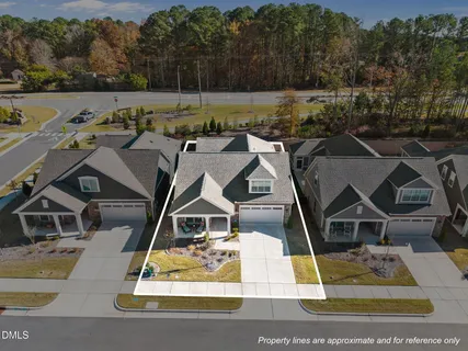 an aerial view of a house with swimming pool and garden