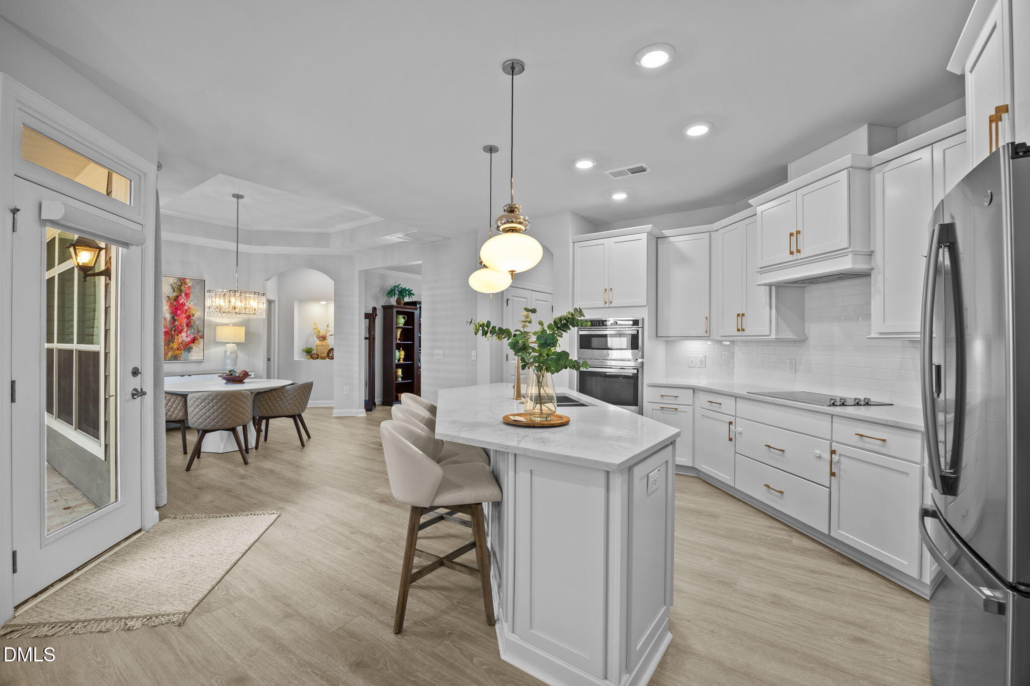 1405 Rich Inlet Cary, NC 27519 - Photo 7 of 44 a kitchen with white cabinets and stainless steel appliances