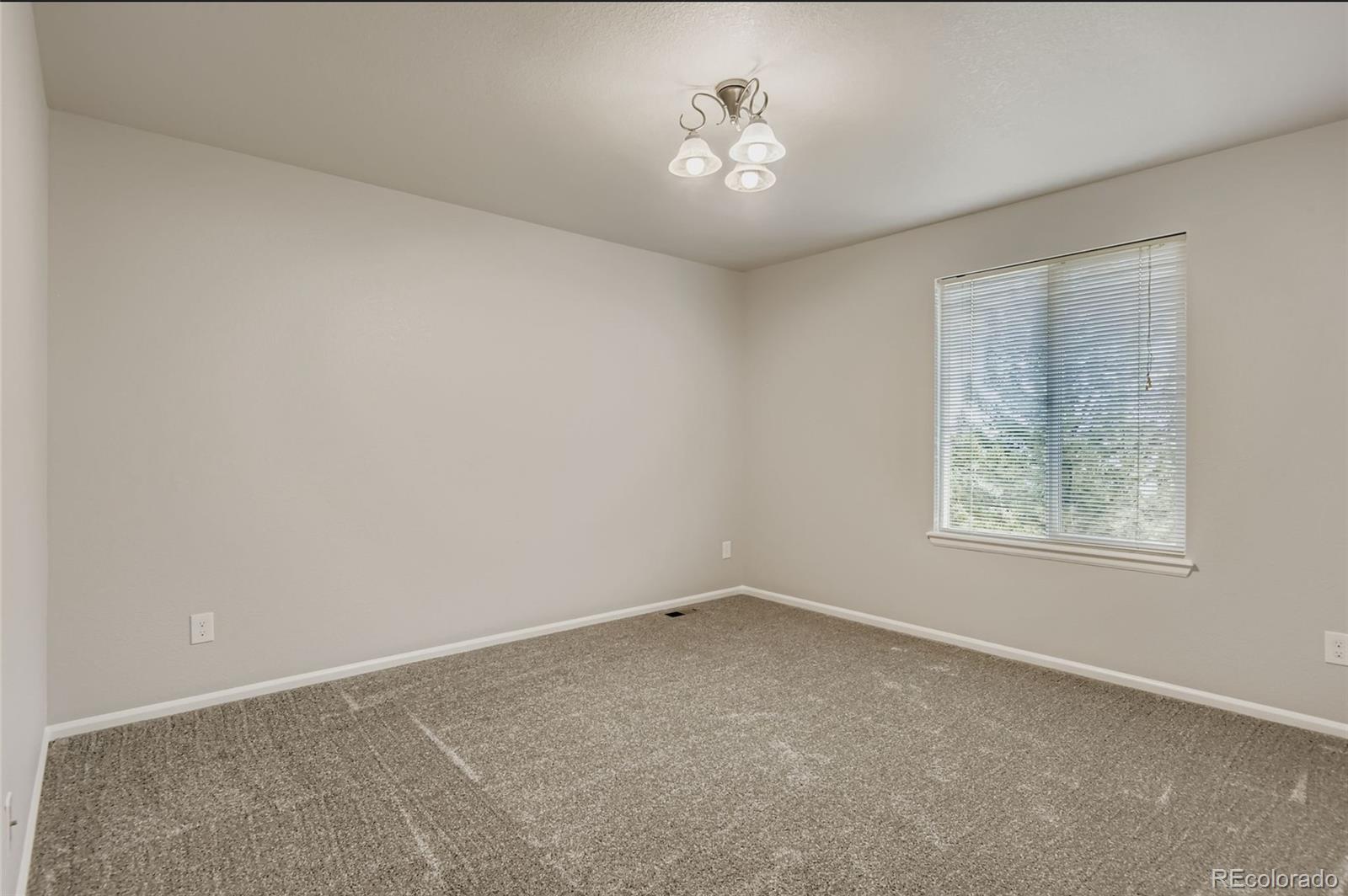 10726 Middlebury Way Highlands Ranch, CO 80126 - Photo 12 of 30 an empty room with a window