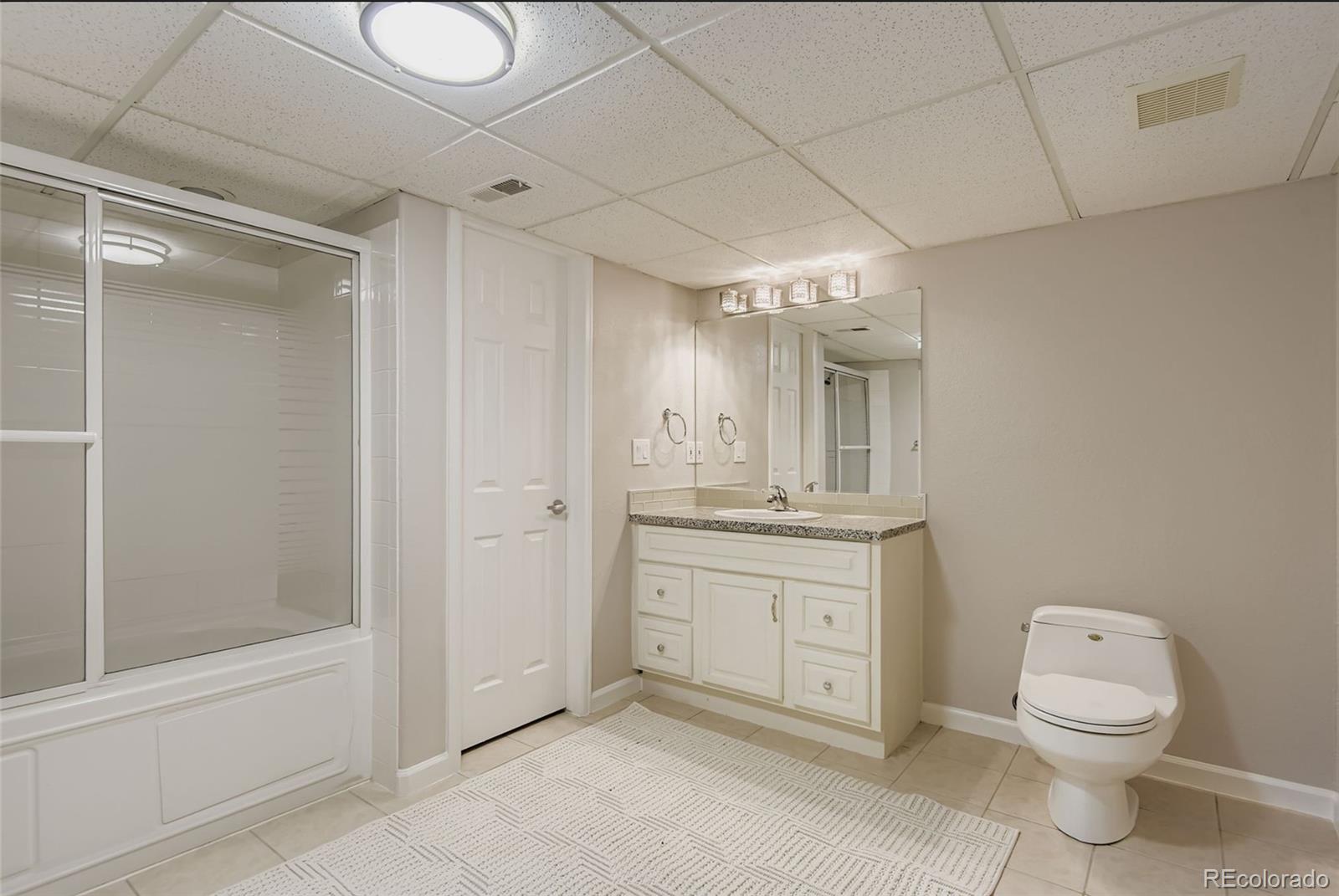 10726 Middlebury Way Highlands Ranch, CO 80126 - Photo 22 of 30 a spacious bathroom with a granite countertop sink a toilet and shower