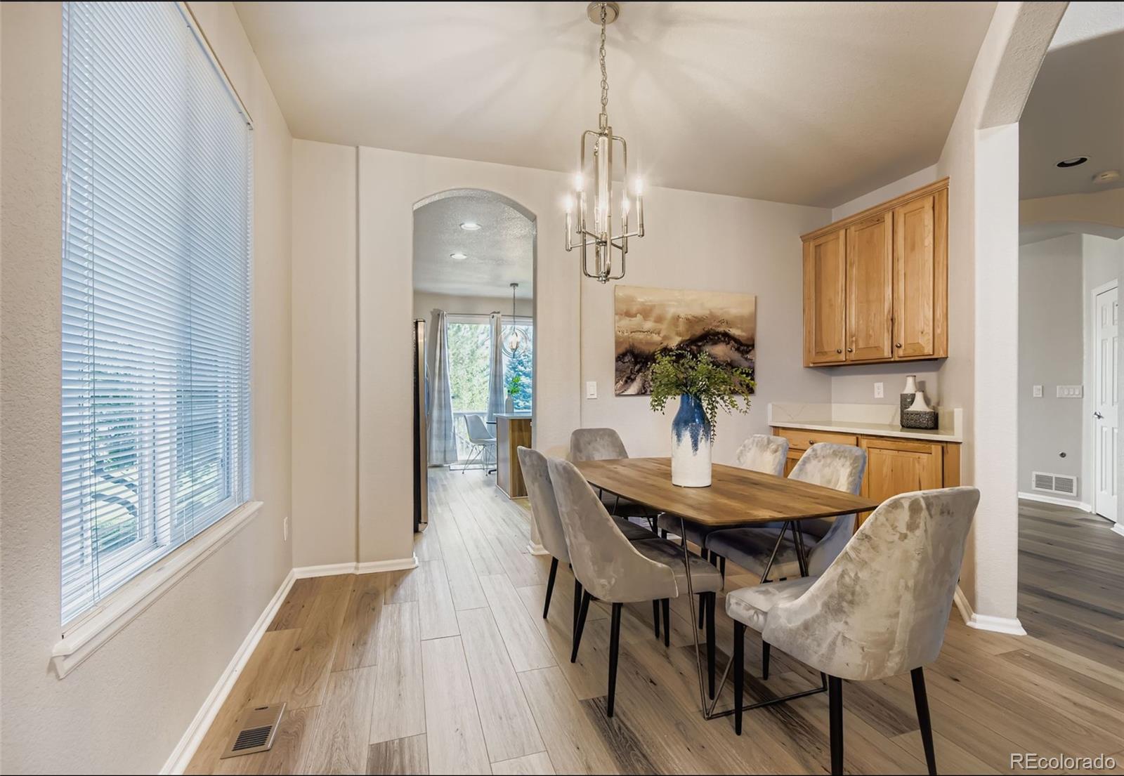 10726 Middlebury Way Highlands Ranch, CO 80126 - Photo 5 of 30 a view of a dining room with furniture window and wooden floor