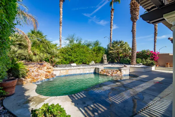 a view of a chairs and table in the patio