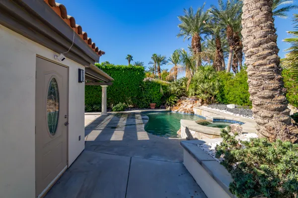 a view of a patio with table and chairs and potted plants