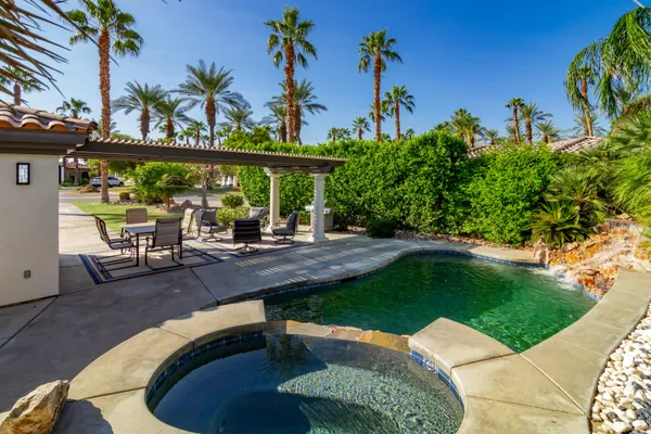 swimming pool view with a seating space