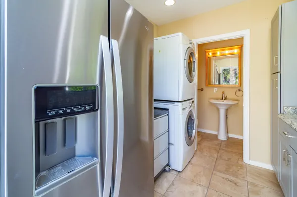 a kitchen with a refrigerator and white cabinets